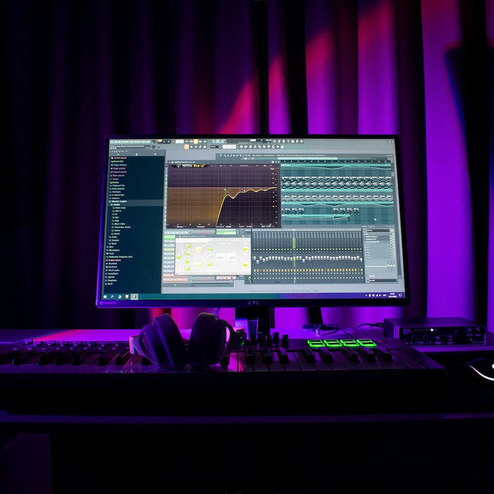 A beginner producer working at a laptop with headphones, starting a new electronic music session