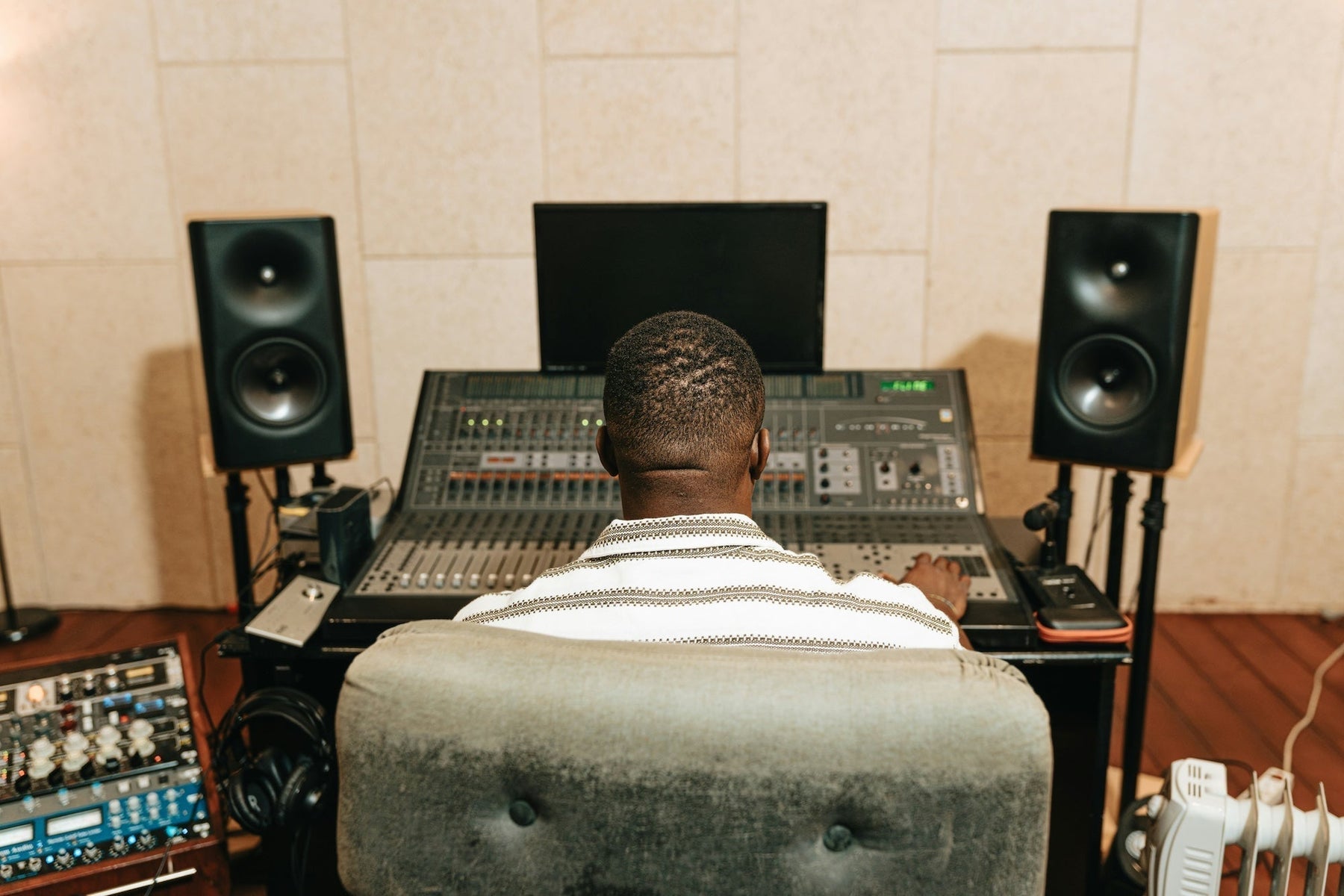 An audio interface and laptop on a producer's desk, ready for a new DAW session