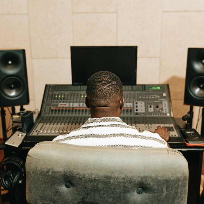 An audio interface and laptop on a producer's desk, ready for a new DAW session