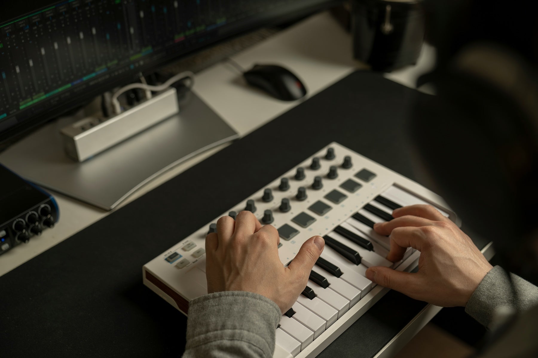 Detuned sawtooth oscillators displayed on a synthesizer screen in a darkened studio