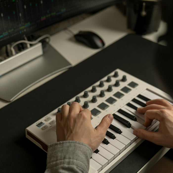 Detuned sawtooth oscillators displayed on a synthesizer screen in a darkened studio