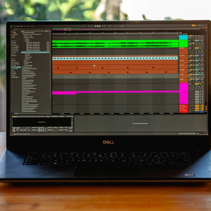 Subwoofer and studio monitors with a dubstep session loaded showing layered bass tracks