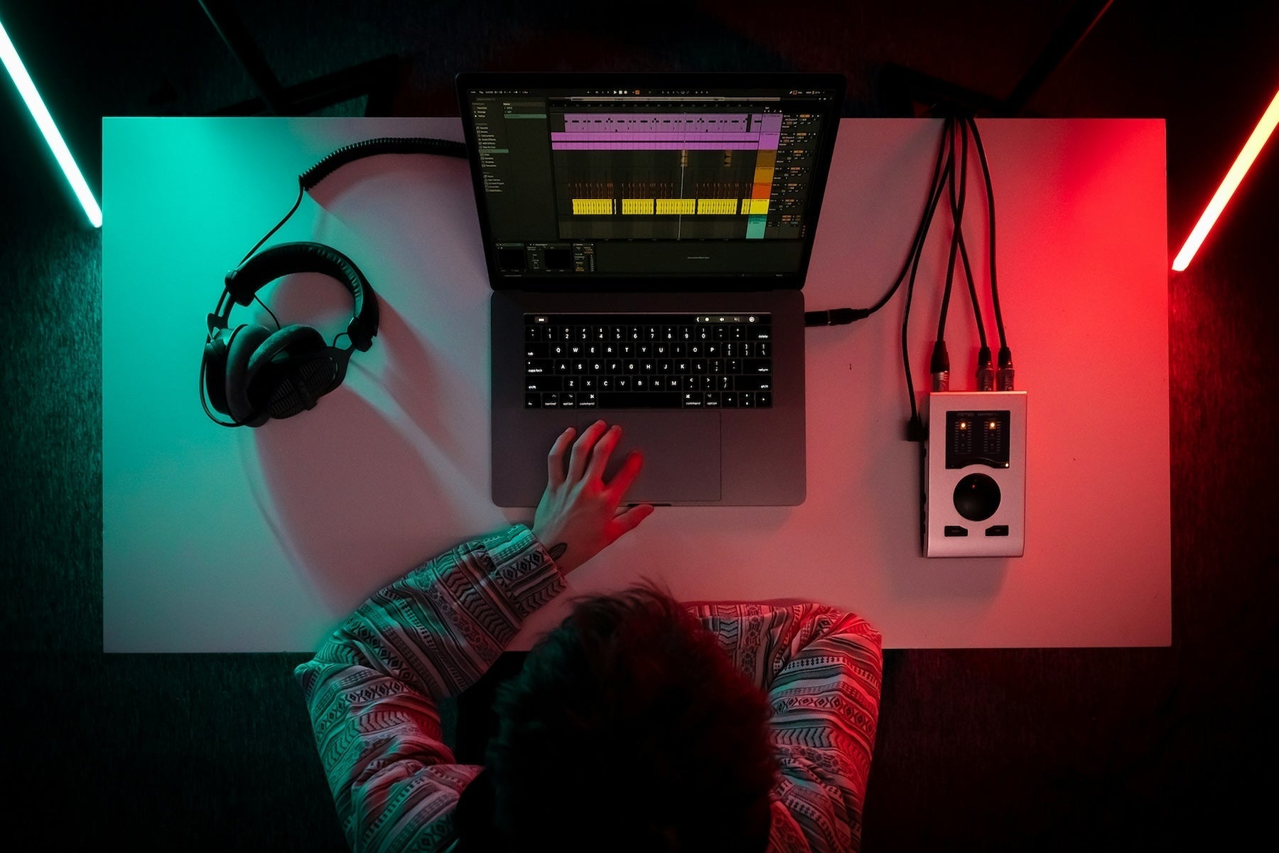 Producer browsing a folder of sample one-shots and dragging them into a DAW for layering