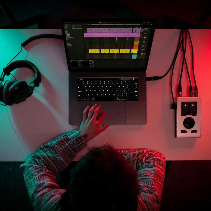 Producer browsing a folder of sample one-shots and dragging them into a DAW for layering