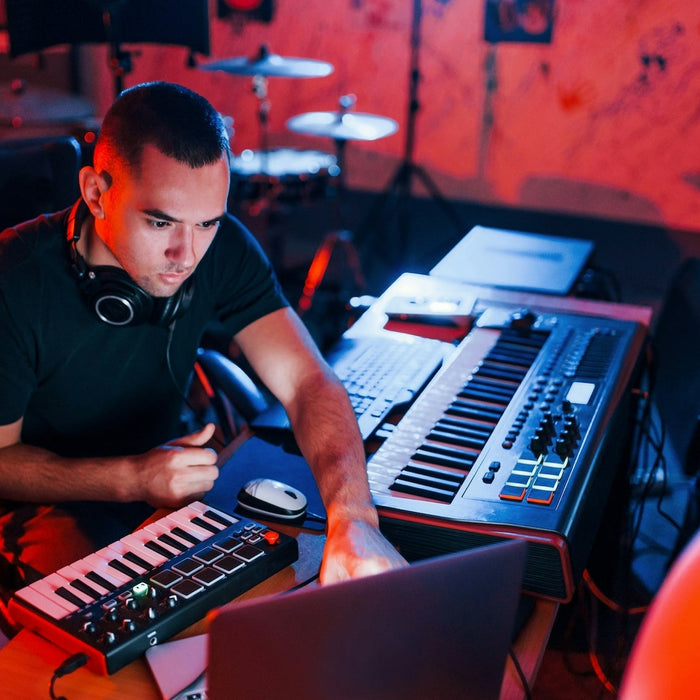 A dubstep producer working on a 140 BPM halftime track at their studio desk