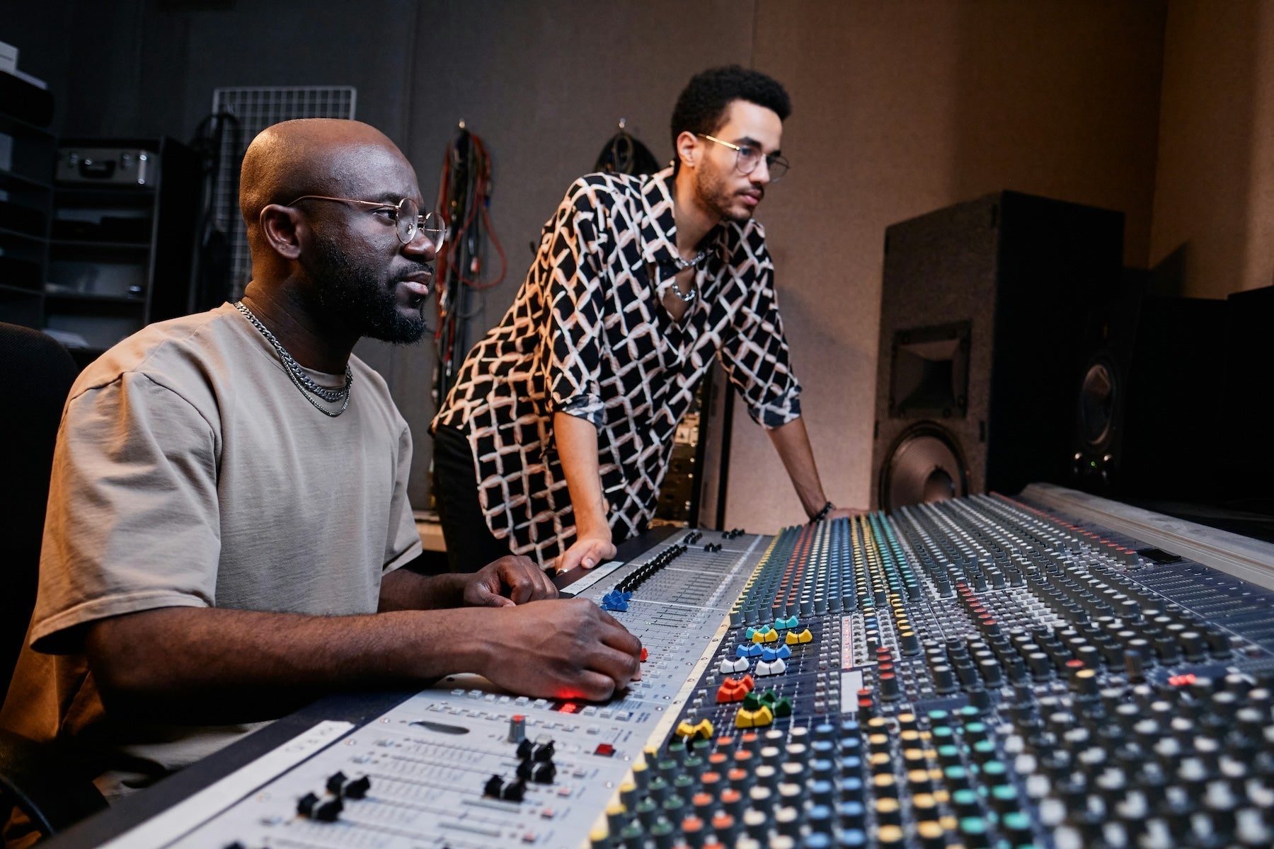 A producer layering kick drum samples at their studio workstation