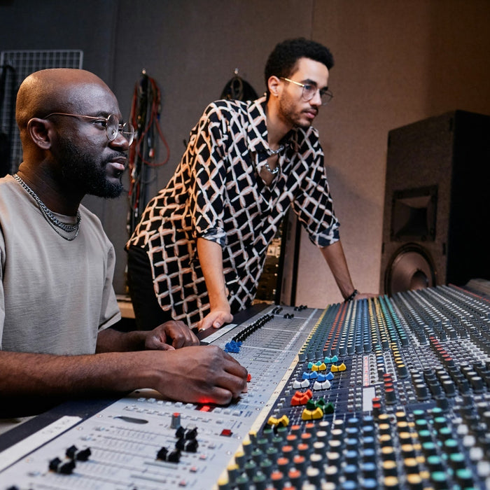 A producer layering kick drum samples at their studio workstation
