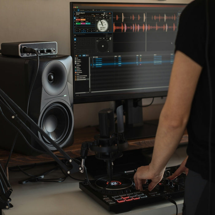 A producer routing sends and returns at their mixing workstation