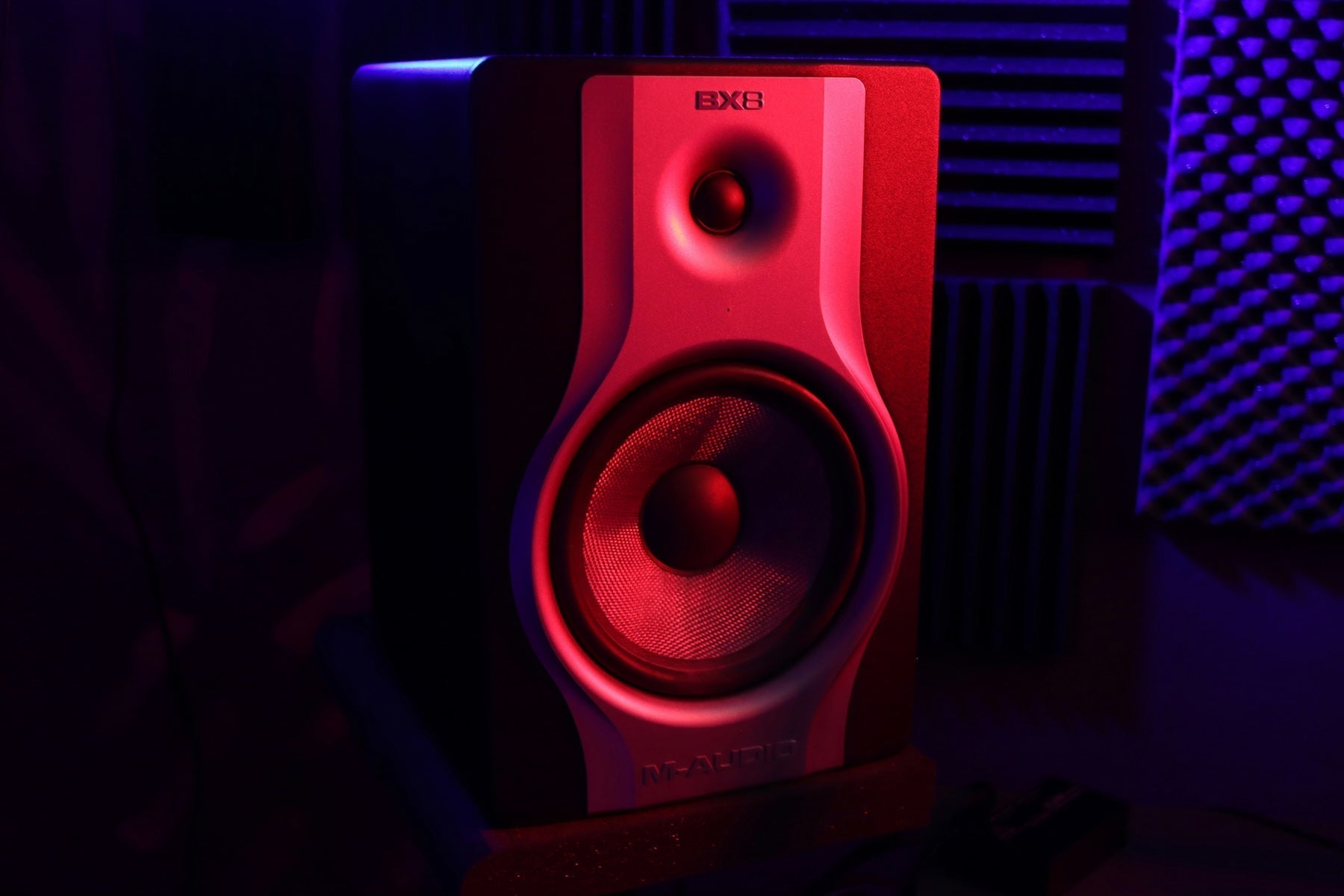 A producer preparing a mix for mastering at a treated studio workstation