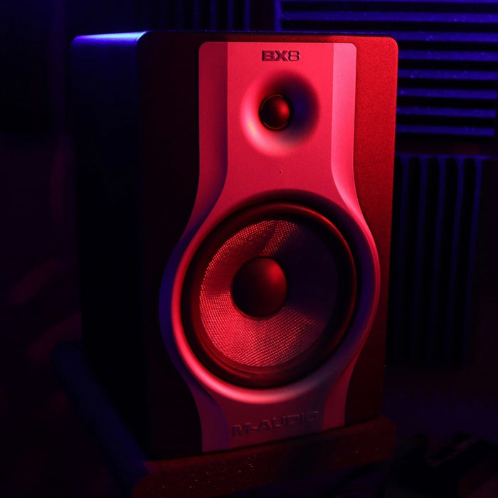 A producer preparing a mix for mastering at a treated studio workstation