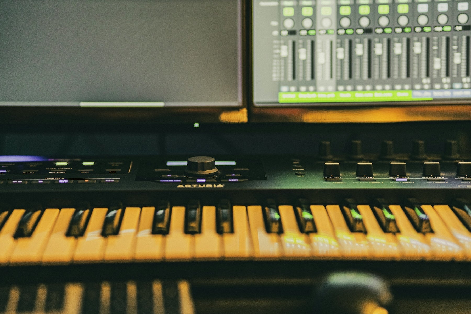 Producer working at a DAW with stereo monitors in a home studio environment