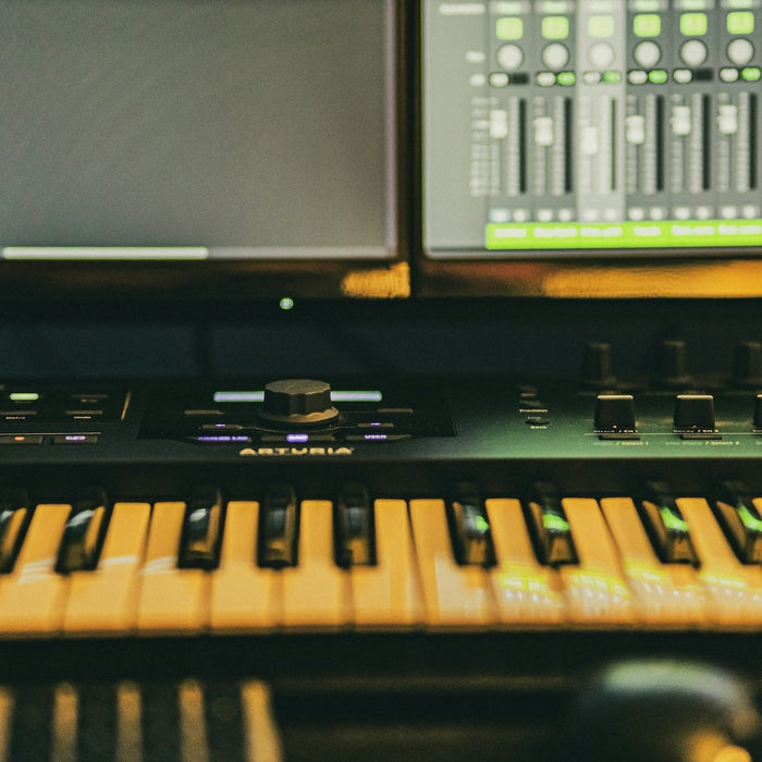 Producer working at a DAW with stereo monitors in a home studio environment