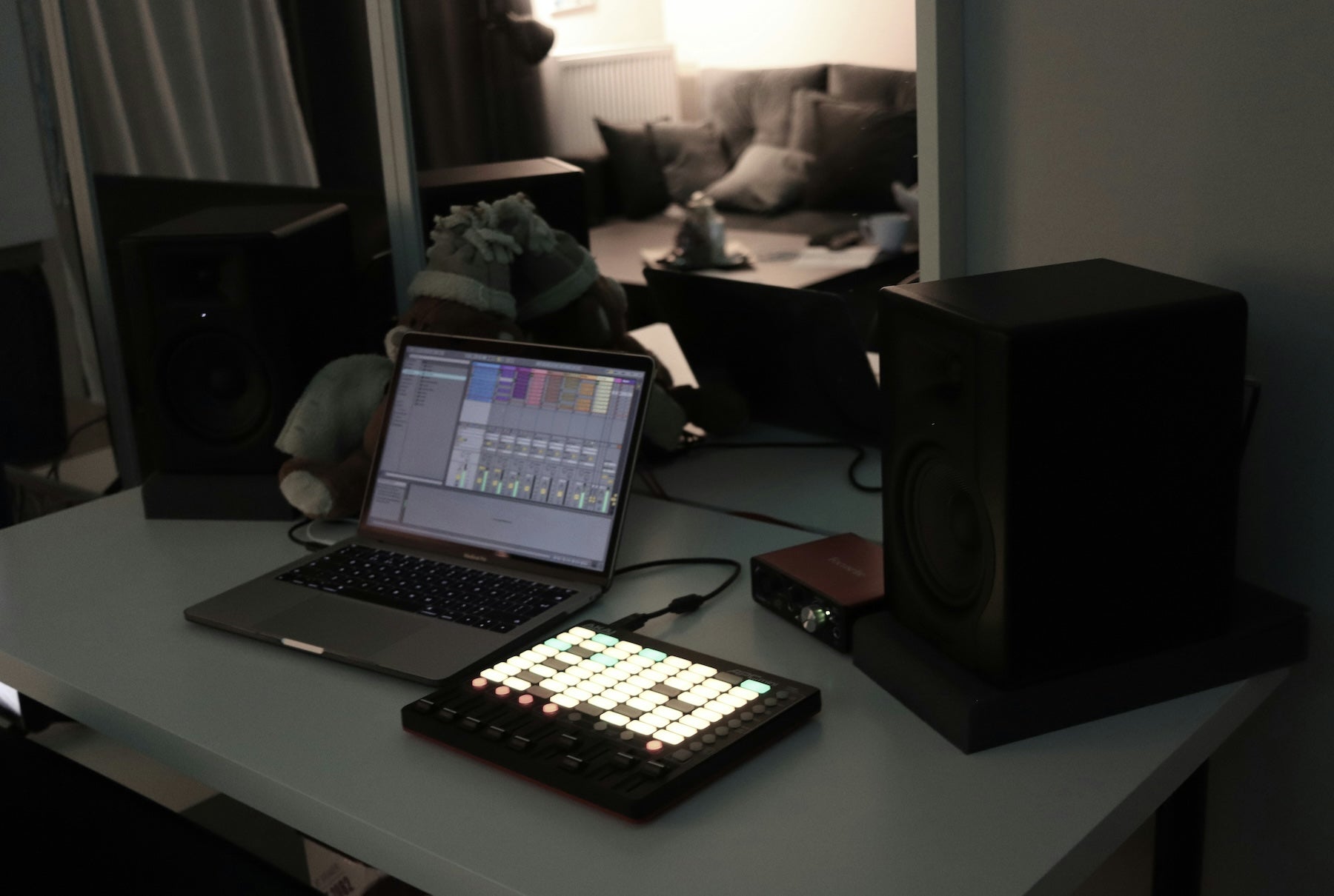 Producer adjusting EQ and compression plugins on the master bus in a DAW