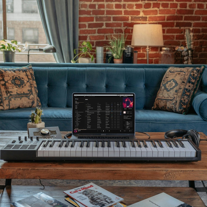 Producer working in a pre-routed DAW template with color-coded tracks and grouped buses