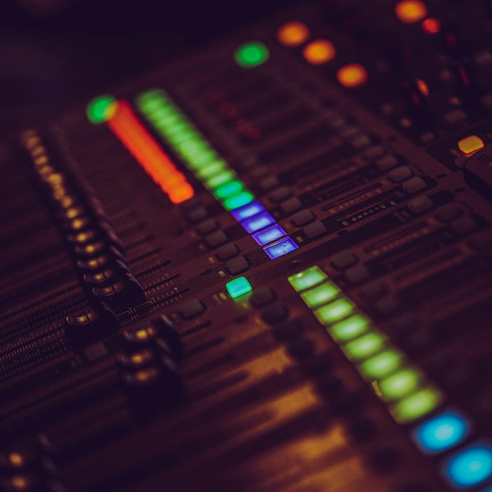 Producer monitoring DAW CPU load while working on a dense session with many active tracks